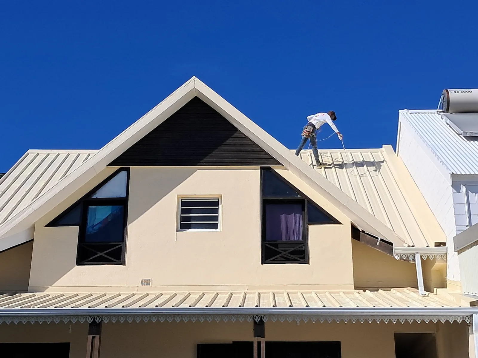 Couvreur HART TOITURE sur le toit d’une maison à La Réunion